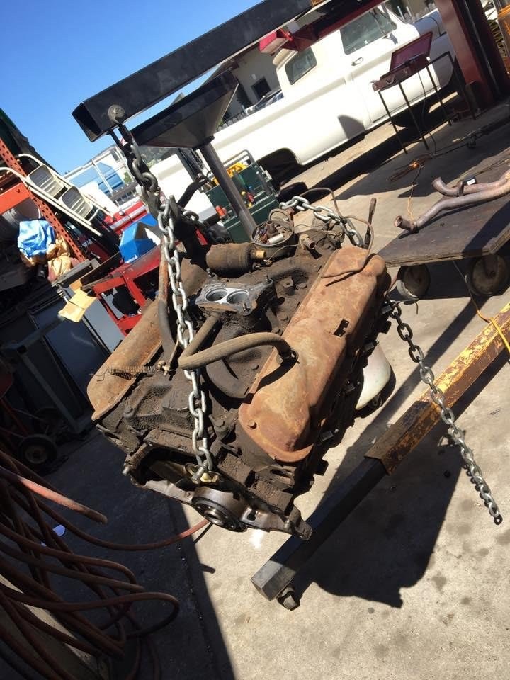 An engine block lifted out on a hoist in the yard at St. Helena Auto Repair.