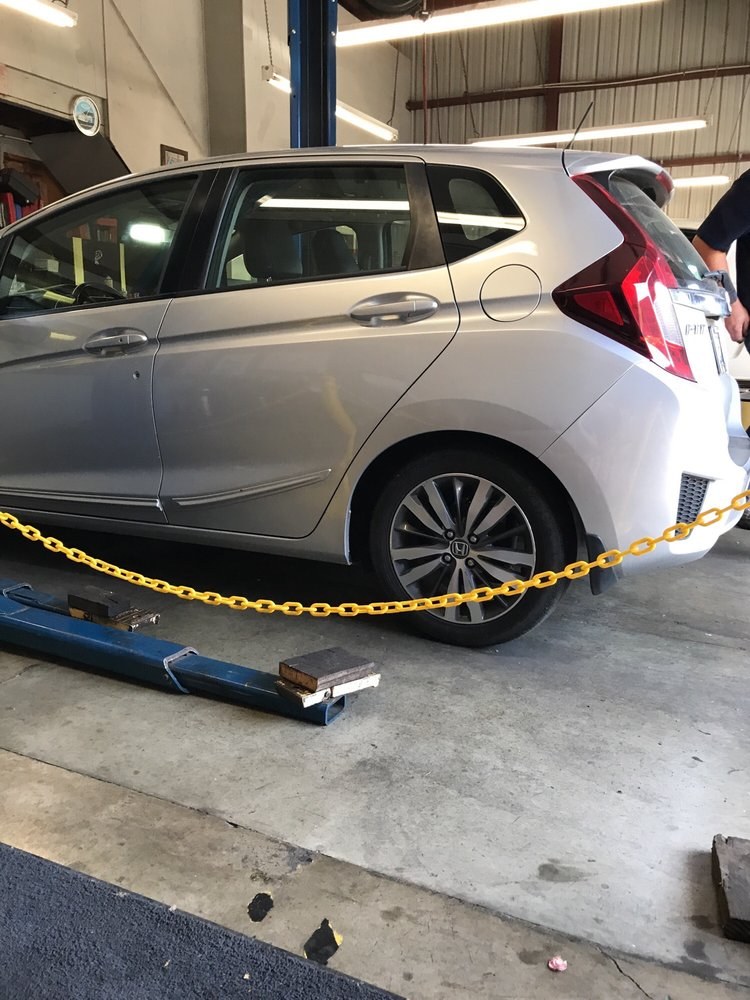 A silver Honda Fit in the service bay at St. Helena Auto Repair.
